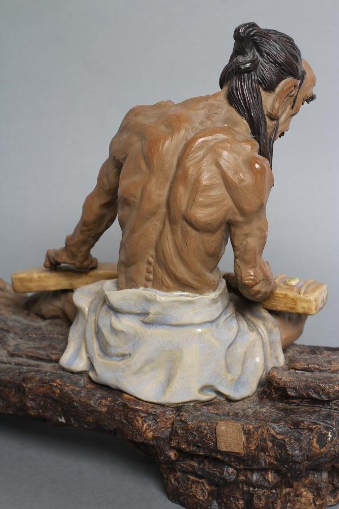 A CHINESE SHIWAN STONEWARE FIGURE Image