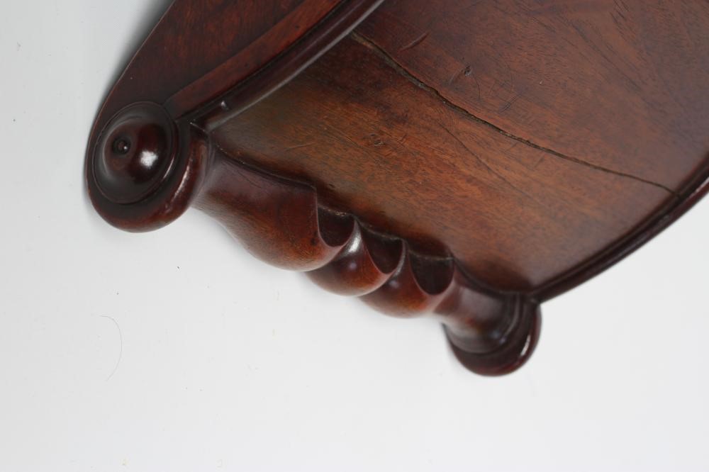 A REGENCY MAHOGANY CHEESE COASTER of typical dished form with centre division Image