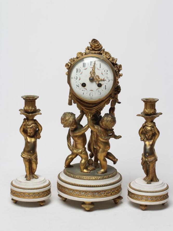 A FRENCH GILT METAL AND WHITE MARBLE CLOCK GARNITURE Image