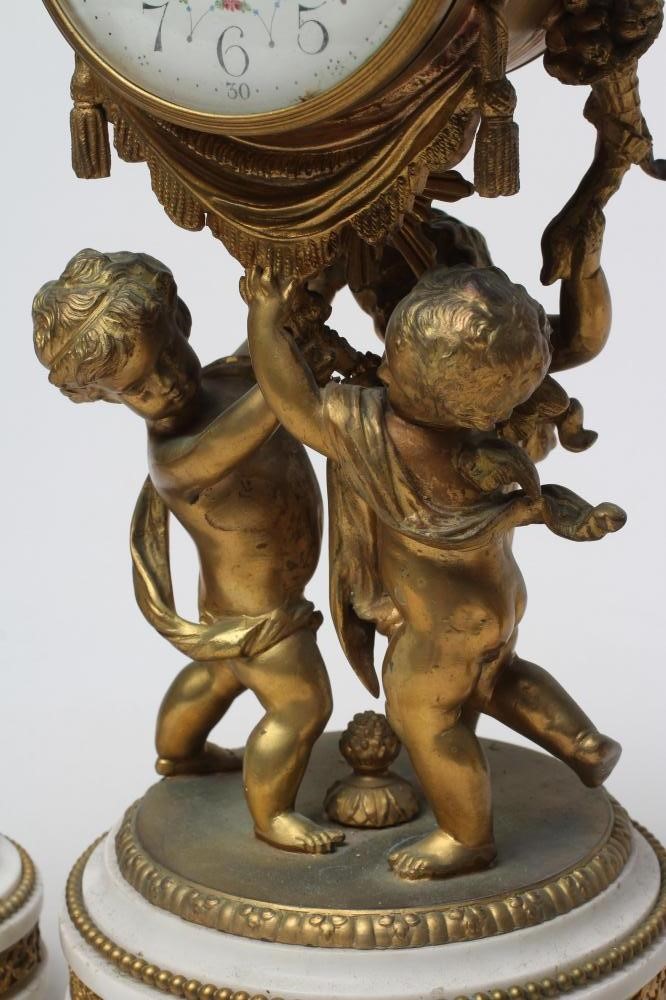 A FRENCH GILT METAL AND WHITE MARBLE CLOCK GARNITURE Image