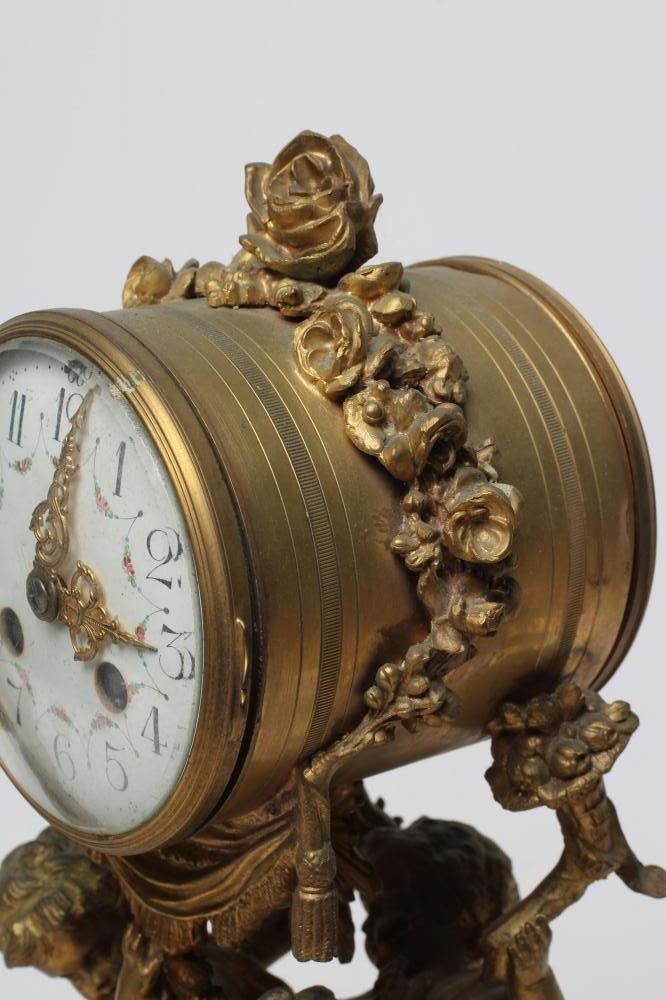 A FRENCH GILT METAL AND WHITE MARBLE CLOCK GARNITURE Image