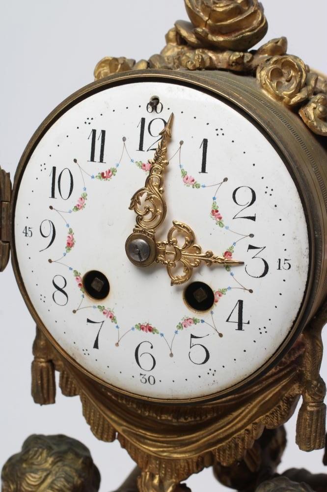 A FRENCH GILT METAL AND WHITE MARBLE CLOCK GARNITURE Image