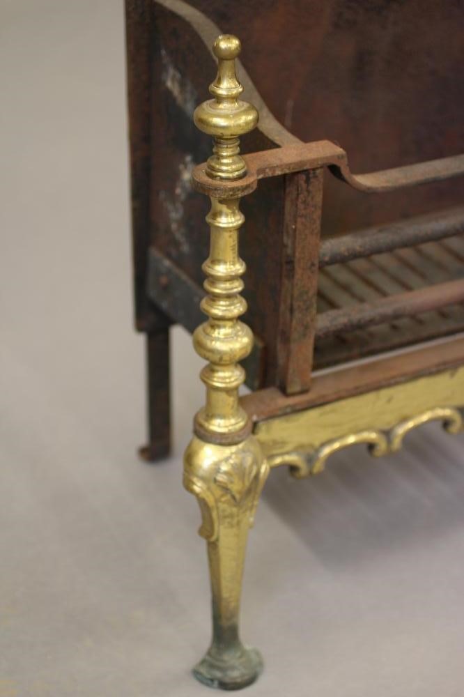 A BAROQUE STYLE CAST IRON AND BRASS FIRE BASKET Image