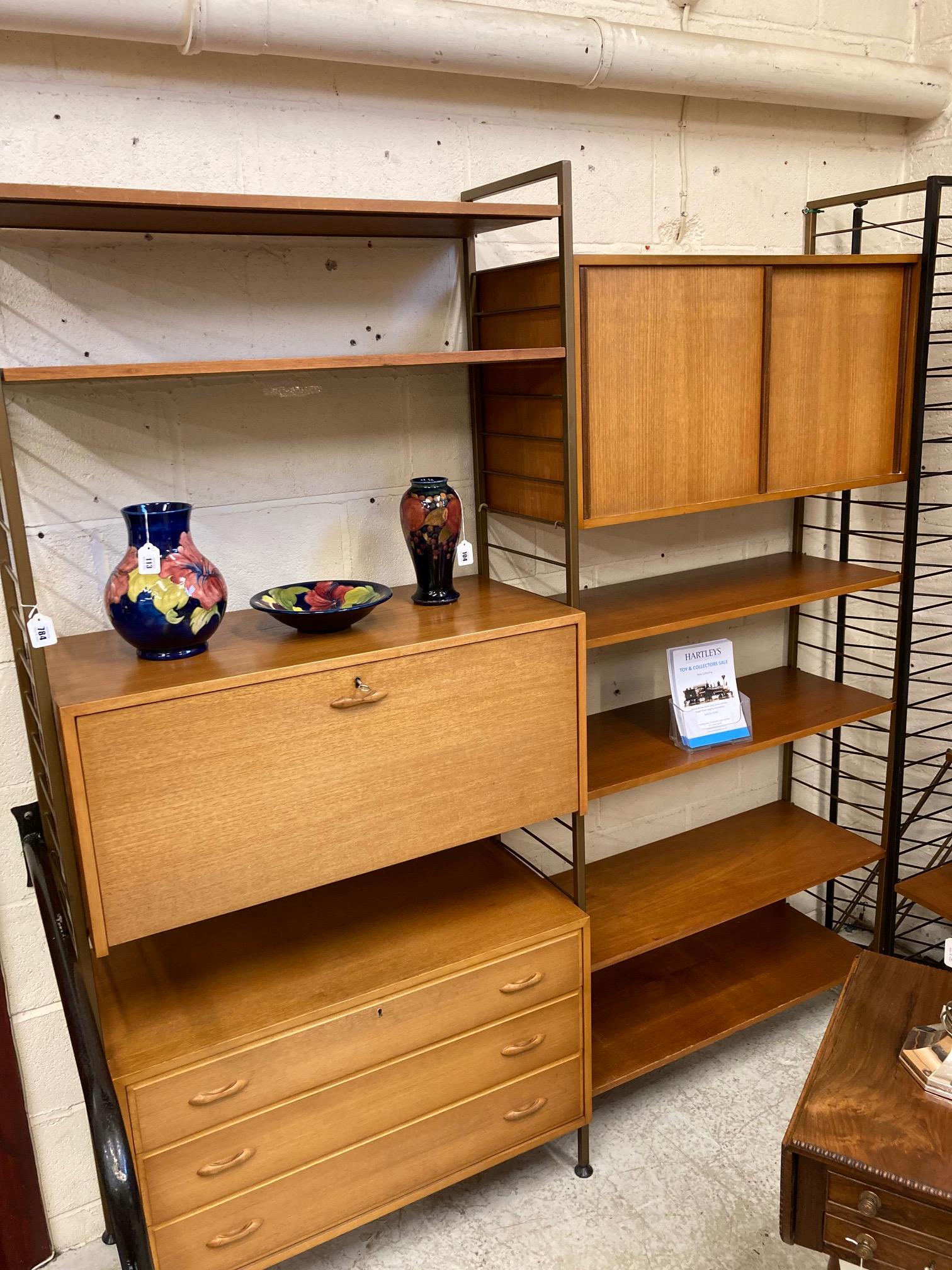 A TEAK LADDERAX TWO BAY UNIT comprising a three drawer chest with wooden lug handles Image