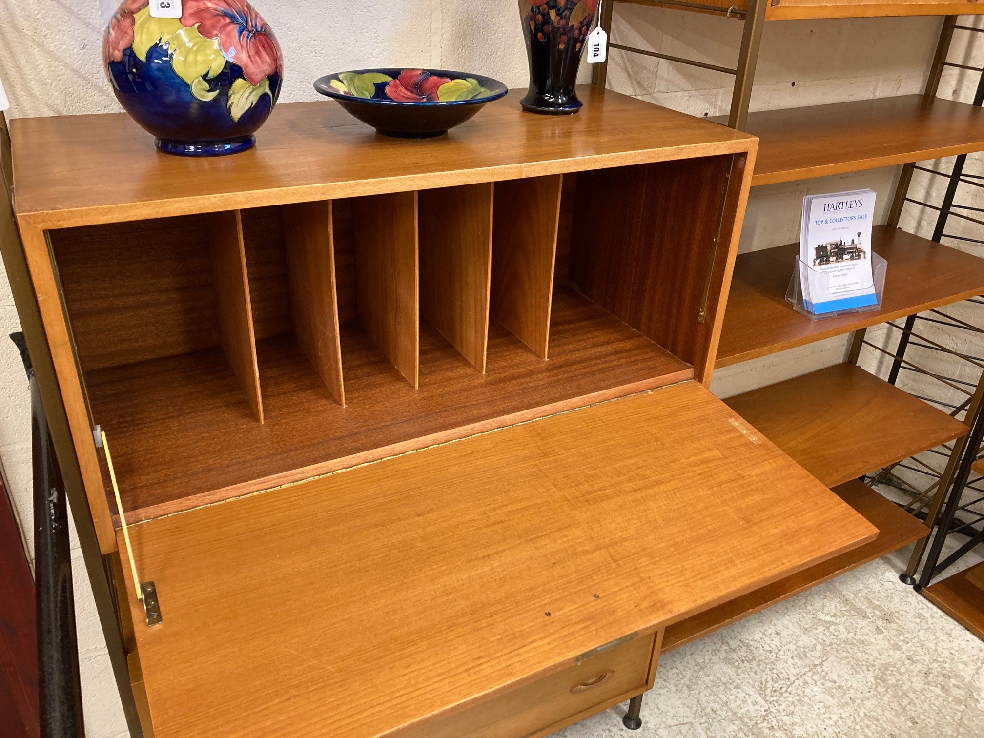 A TEAK LADDERAX TWO BAY UNIT comprising a three drawer chest with wooden lug handles Image