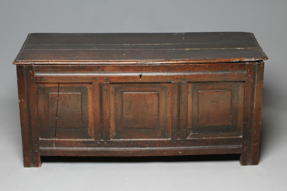 AN OAK PANELLED COFFER Image