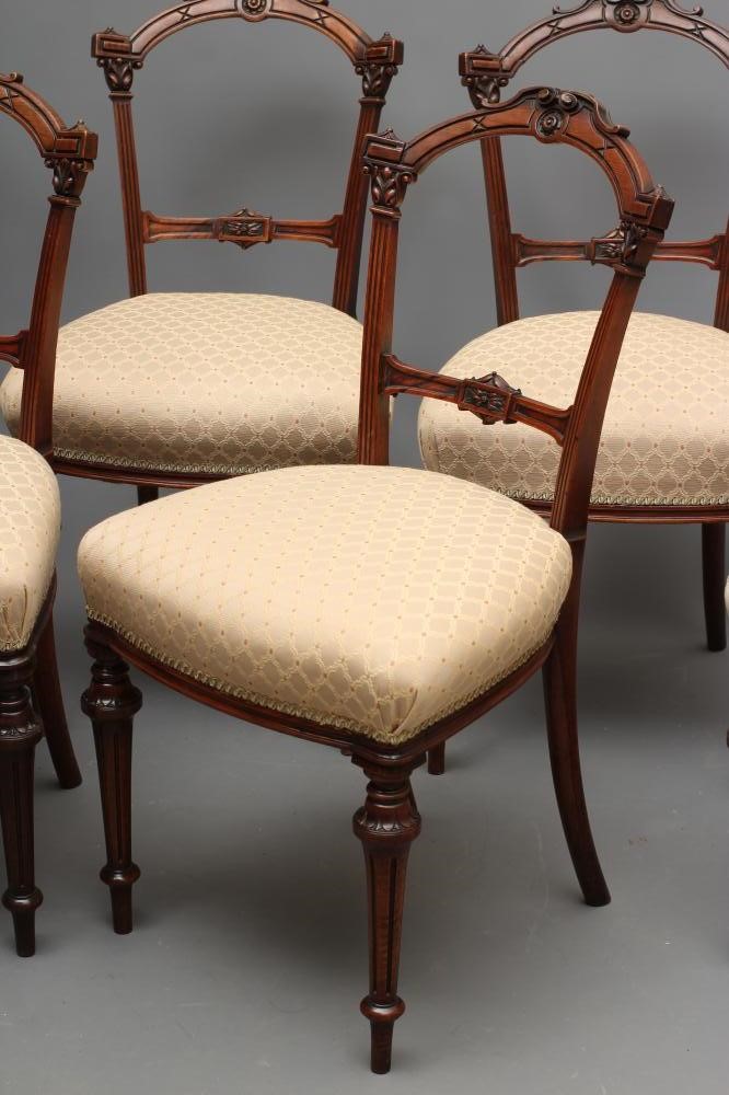 A SET OF SIX VICTORIAN WALNUT DINING CHAIRS upholstered in a cream and rust weave Image