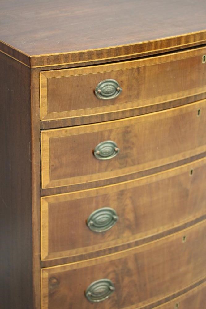 A MAHOGANY BOWED CHEST Image