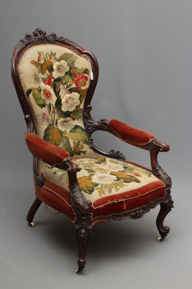 A VICTORIAN ROSEWOOD SHOW FRAME ARMCHAIR of spoonback form carved with trailing flowers and foliage Image