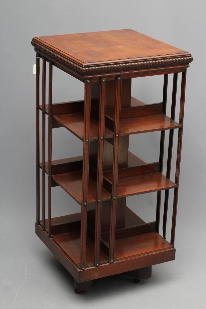 A LATE VICTORIAN MAHOGANY REVOLVING BOOKCASE of three tier square form with part slatted sides Image
