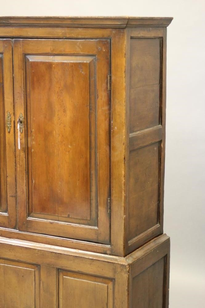 A GEORGIAN PINE PANELLED CLOTHES CUPBOARD Image
