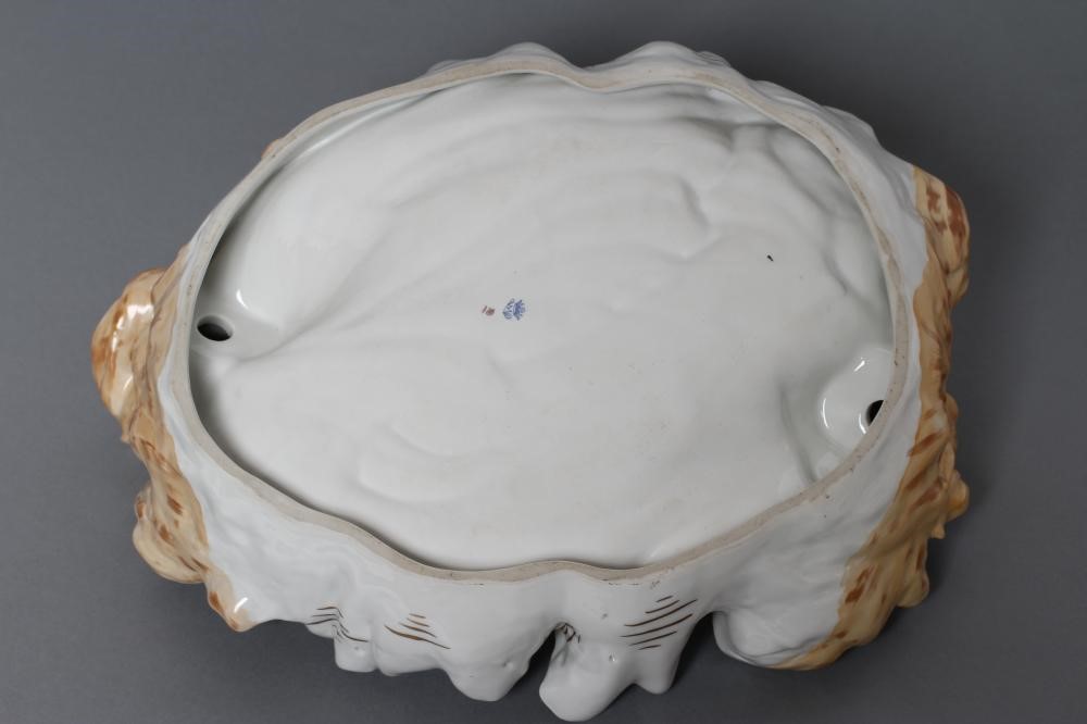 A CONTINENTAL PORCELAIN CENTRE DISH modelled as two maidens wearing flowing green and pink tinted Image