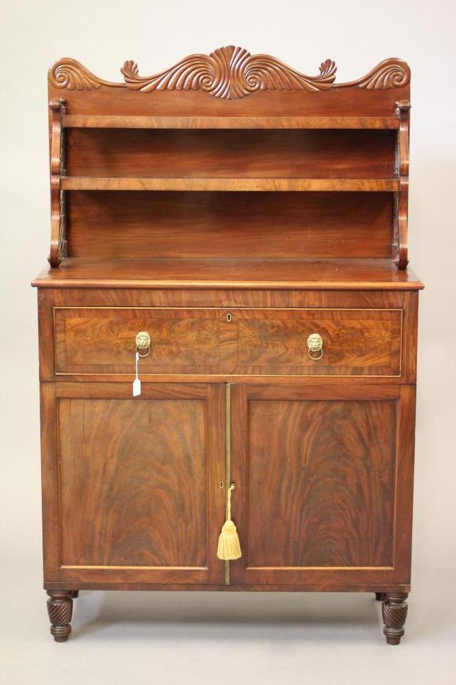 A LATE REGENCY MAHOGANY SECRETAIRE CABINET Image