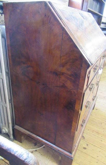A GEORGIAN BURR WALNUT AND FEATHER BANDED BUREAU Image