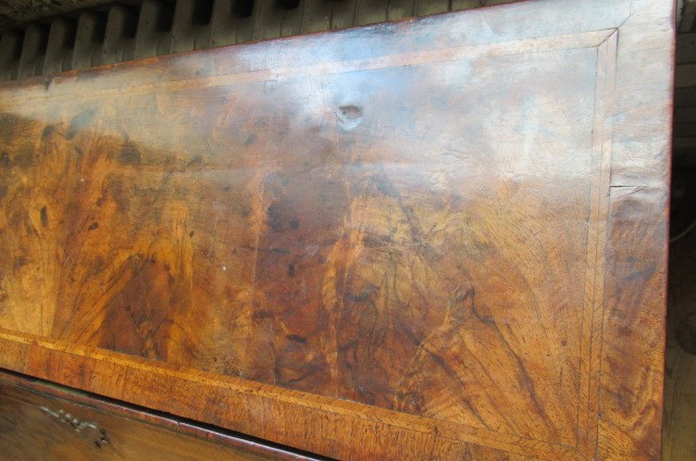 A GEORGIAN BURR WALNUT AND FEATHER BANDED BUREAU Image