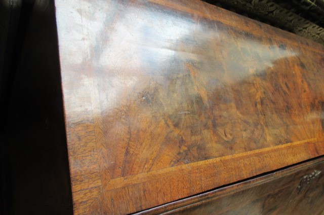 A GEORGIAN BURR WALNUT AND FEATHER BANDED BUREAU Image