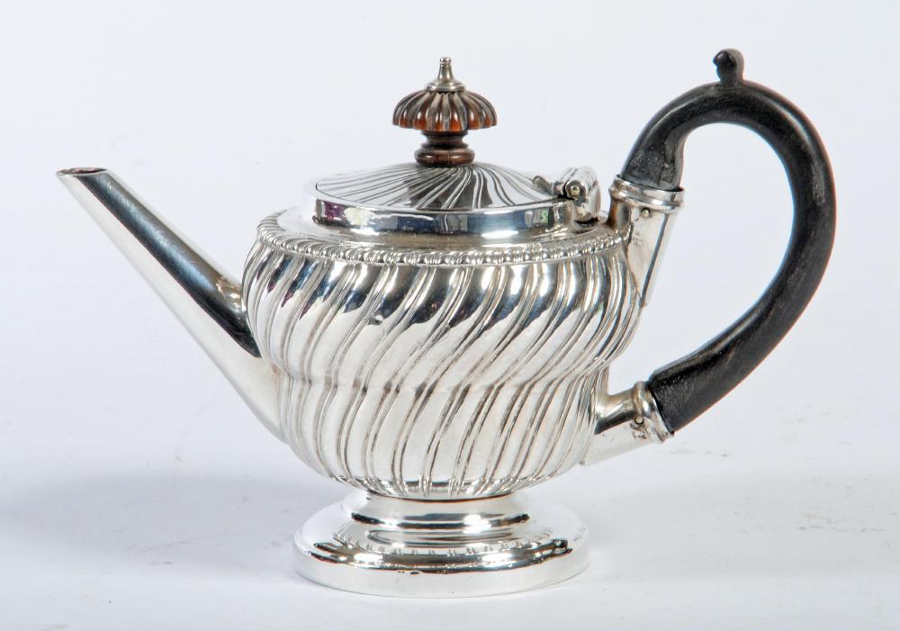 A BACHELOR'S LATE GEORGE III SILVER TEAPOT Image