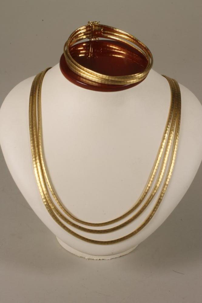 A 1960's 18K GOLD TRIPLE STRAND NECKLACE AND MATCHING BRACELET Image