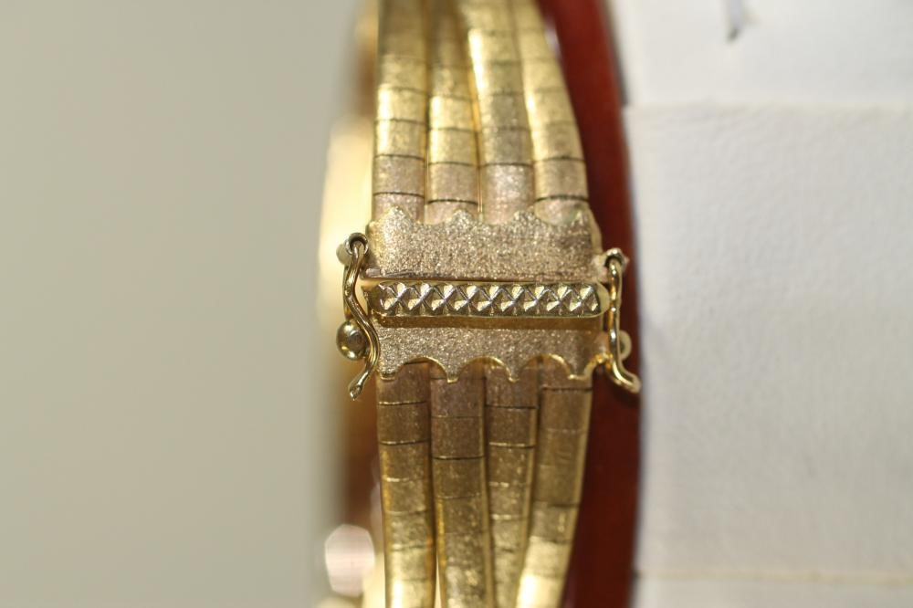 A 1960's 18K GOLD TRIPLE STRAND NECKLACE AND MATCHING BRACELET Image