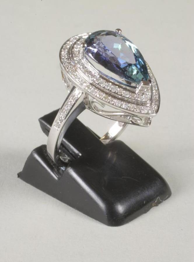 A TANZANITE AND DIAMOND CLUSTER RING Image