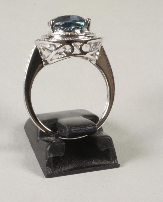 A TANZANITE AND DIAMOND CLUSTER RING Image