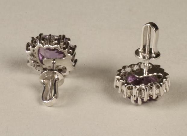 A PAIR OF AMETHYST AND DIAMOND CLUSTER EAR STUDS Image