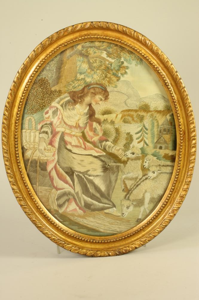 A LATE GEORGE III OVAL SILK PICTURE worked in coloured silks with an Arcadian shepherdess with Image