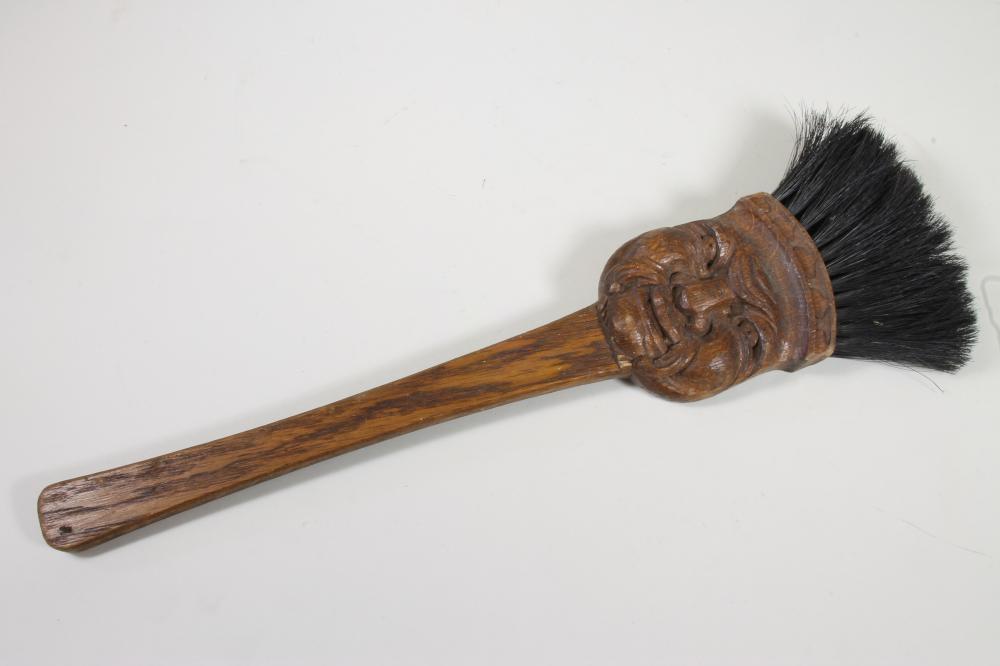 AN OAK FIRE BRUSH carved with a grotesque mask Image