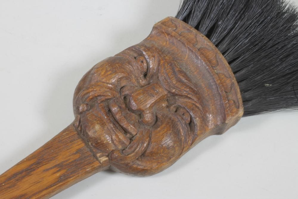 AN OAK FIRE BRUSH carved with a grotesque mask Image