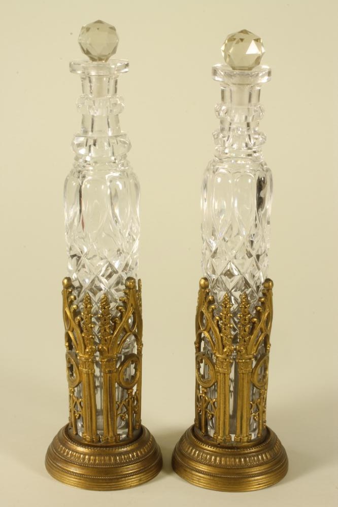 A PAIR OF VICTORIAN BRASS PUGINESQUE COLOGNE BOTTLE HOLDERS Image