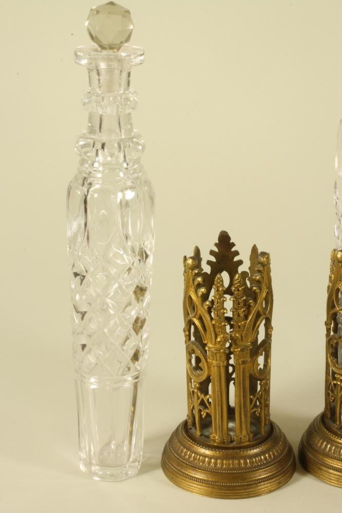 A PAIR OF VICTORIAN BRASS PUGINESQUE COLOGNE BOTTLE HOLDERS Image