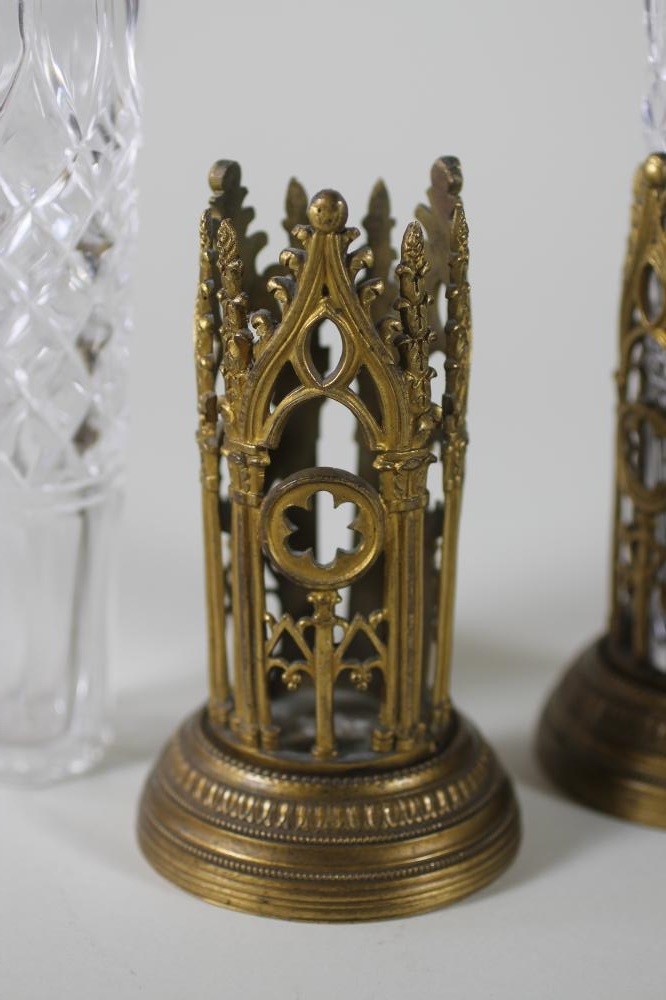 A PAIR OF VICTORIAN BRASS PUGINESQUE COLOGNE BOTTLE HOLDERS Image