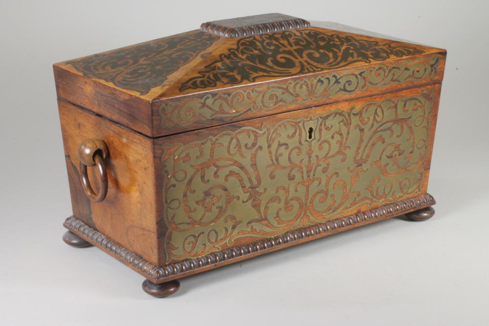 A REGENCY ROSEWOOD TEA CADDY of sarcophagus form with ring handles and raised upon four bun feet Image