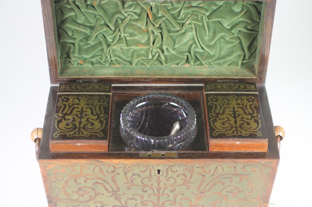 A REGENCY ROSEWOOD TEA CADDY of sarcophagus form with ring handles and raised upon four bun feet Image