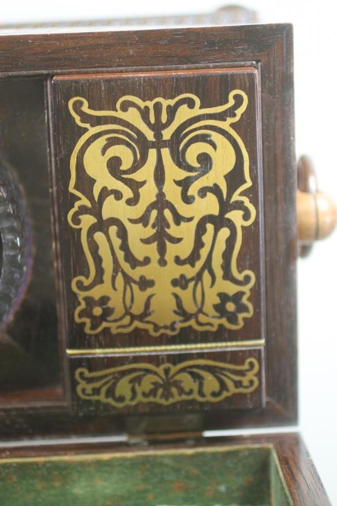 A REGENCY ROSEWOOD TEA CADDY of sarcophagus form with ring handles and raised upon four bun feet Image