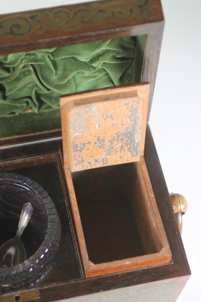 A REGENCY ROSEWOOD TEA CADDY of sarcophagus form with ring handles and raised upon four bun feet Image