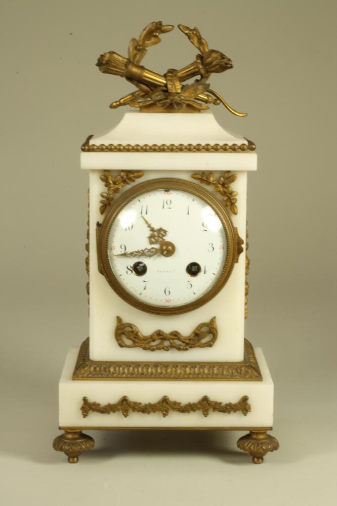 A FRENCH WHITE MARBLE AND GILT METAL MANTEL CLOCK Image