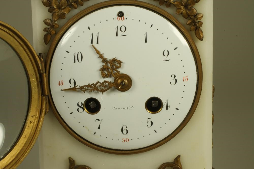 A FRENCH WHITE MARBLE AND GILT METAL MANTEL CLOCK Image