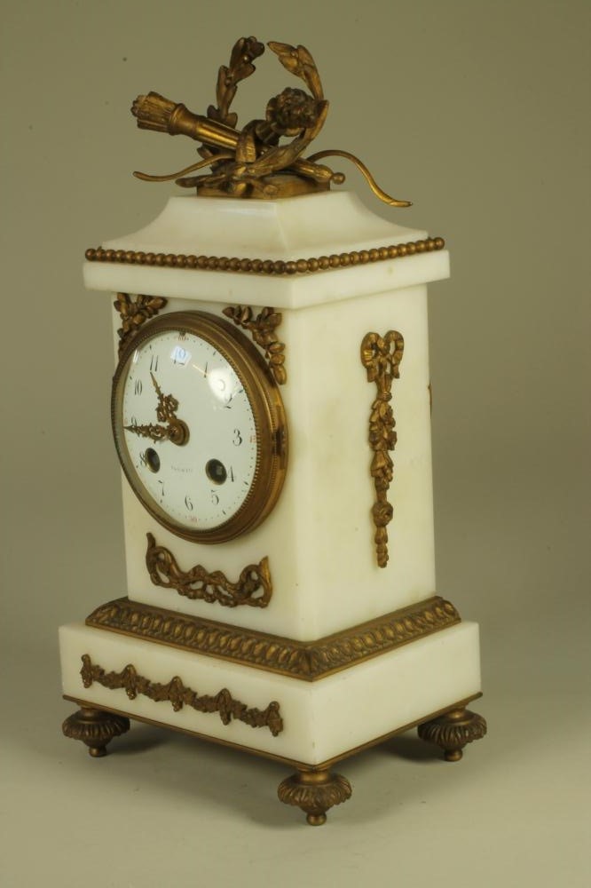 A FRENCH WHITE MARBLE AND GILT METAL MANTEL CLOCK Image