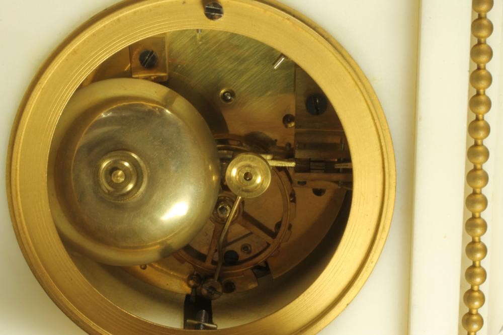 A FRENCH WHITE MARBLE AND GILT METAL MANTEL CLOCK Image