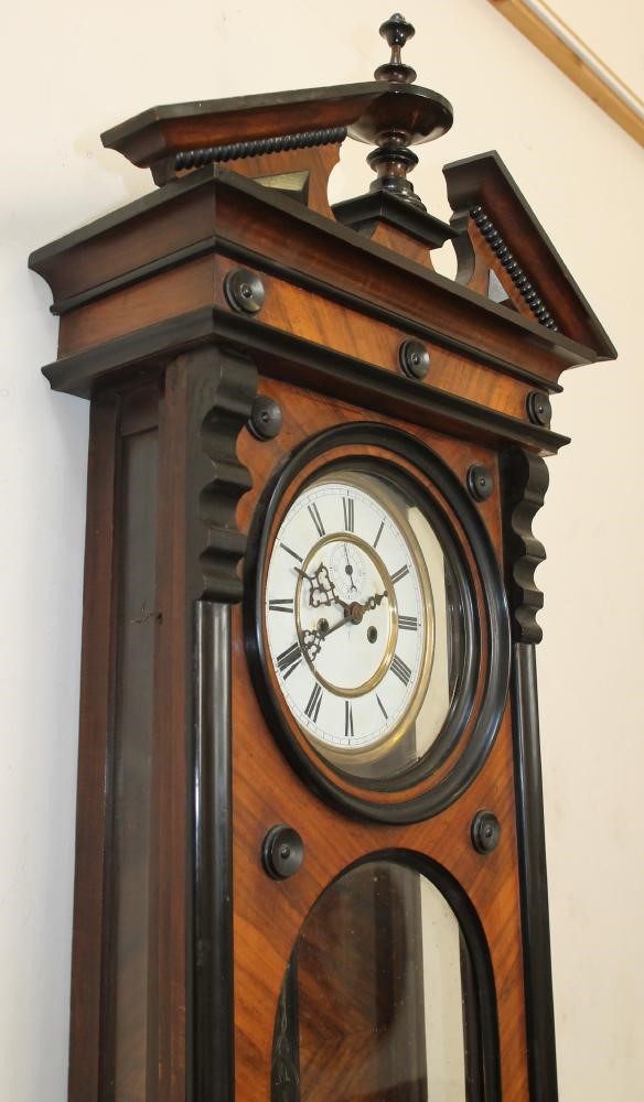 A GERMAN WALNUT CASED TIMEPIECE Image