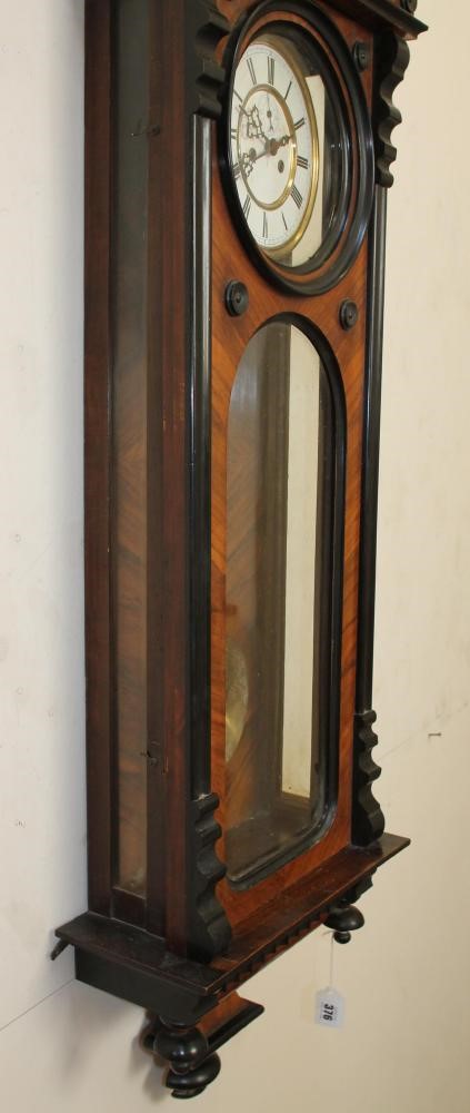 A GERMAN WALNUT CASED TIMEPIECE Image