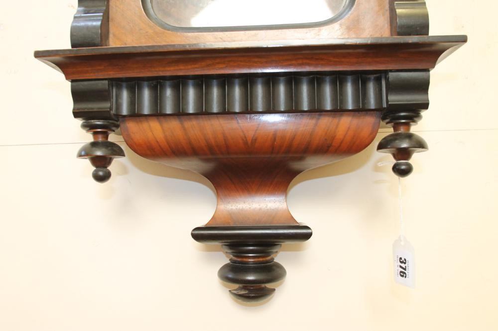 A GERMAN WALNUT CASED TIMEPIECE Image