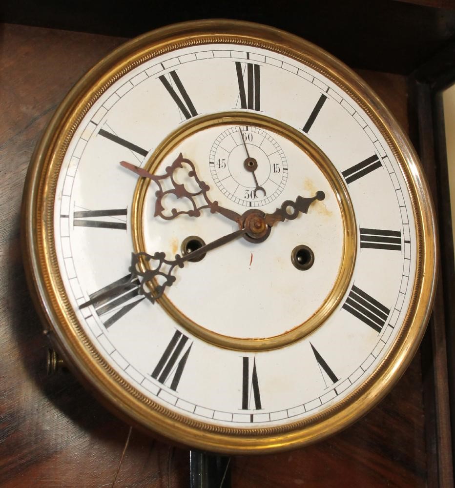 A GERMAN WALNUT CASED TIMEPIECE Image