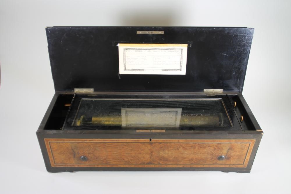 A SWISS WALNUT CASED MUSICAL BOX Image