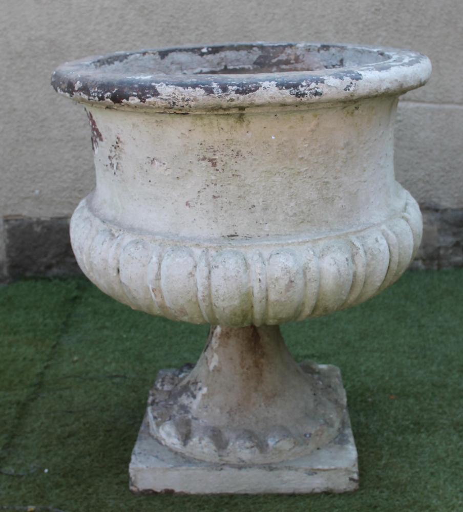 A VICTORIAN TERRACOTTA URN of circular half fluted form with broad flat moulded rim Image