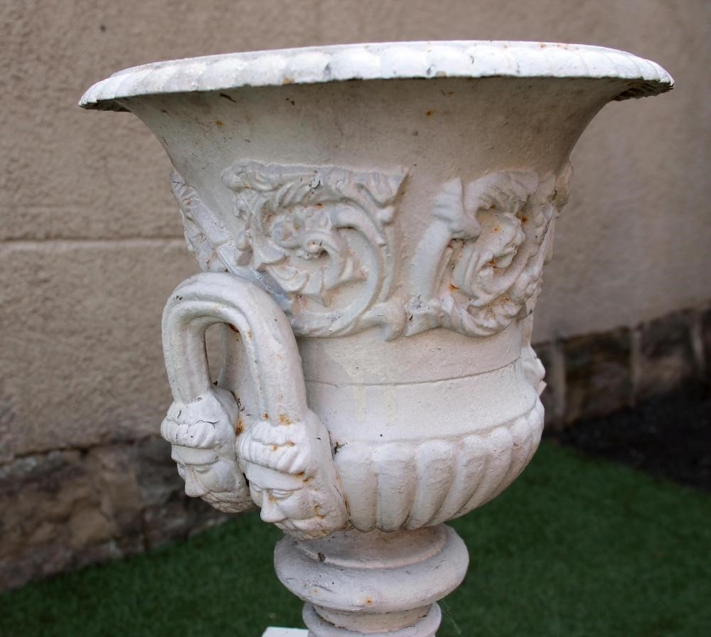 A VICTORIAN CAST IRON URN of half fluted campana form with beaded rim Image