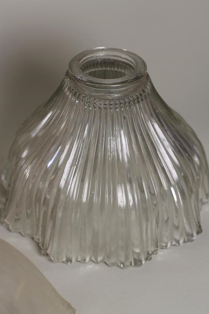 A SET OF FOUR HALOFLAME CLEAR GLASS LAMP SHADES of ribbed bell form with waved rim Image