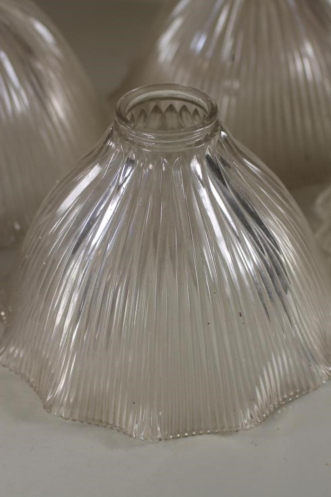 A SET OF FOUR HALOFLAME CLEAR GLASS LAMP SHADES of ribbed bell form with waved rim Image