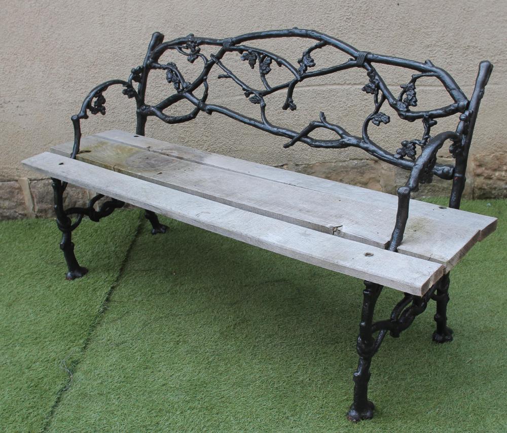 A VICTORIAN CAST IRON  GARDEN SEAT in "rustic" pattern with truncated branch and berried leaf design Image